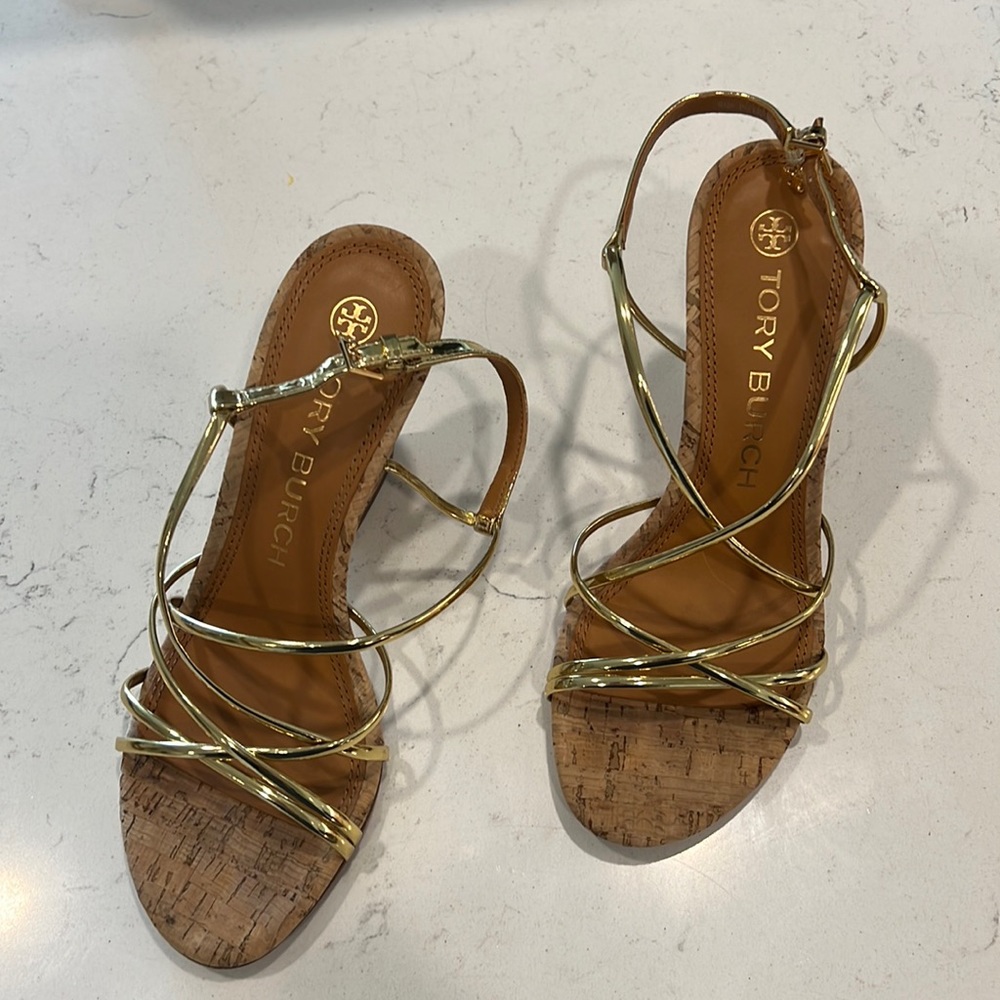 Gold Tory Burch strapped heeled sandals.